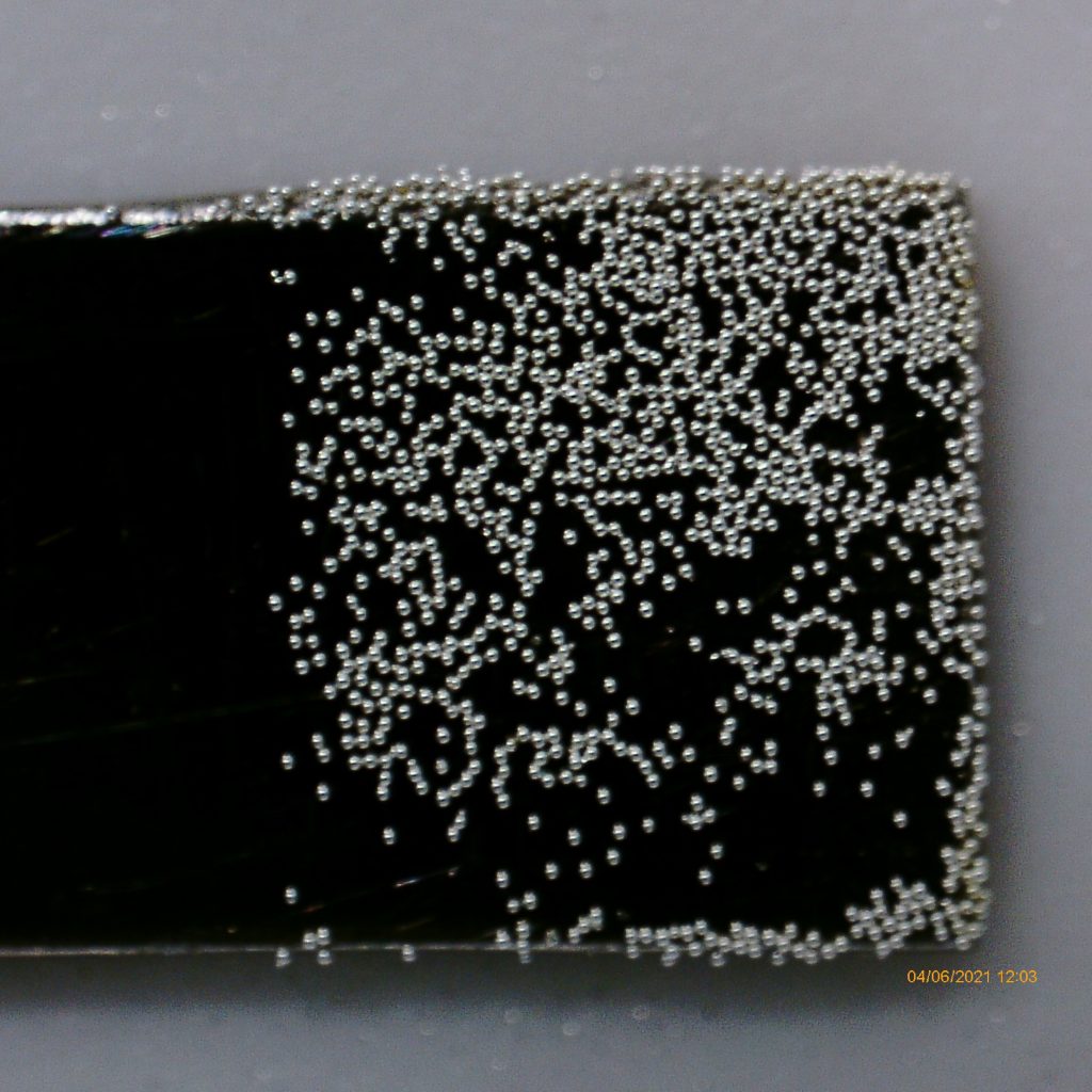 Glass microspheres mounted on a carbon composite tool